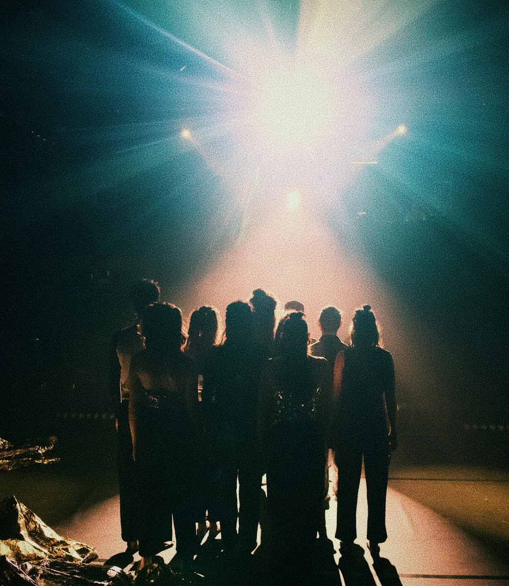 Performers on a brightly lit Thai cabaret stage